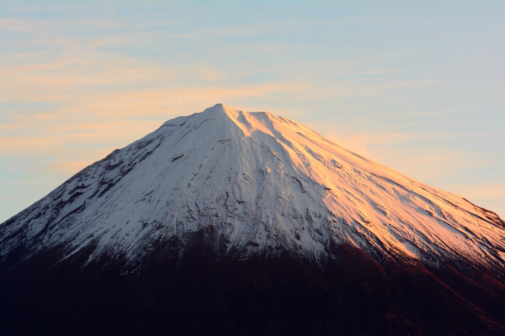 朝日に染まる富士山。拡大すると山頂付近に飛行機が小さく見えます